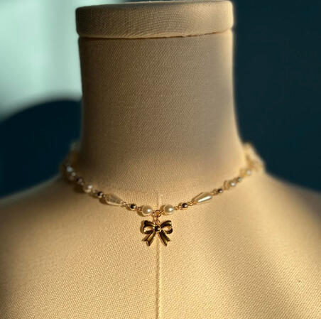 | Gold Bow Necklace | $15 |