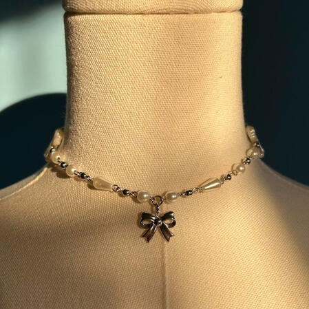 | Silver Bow Necklace | $15 |